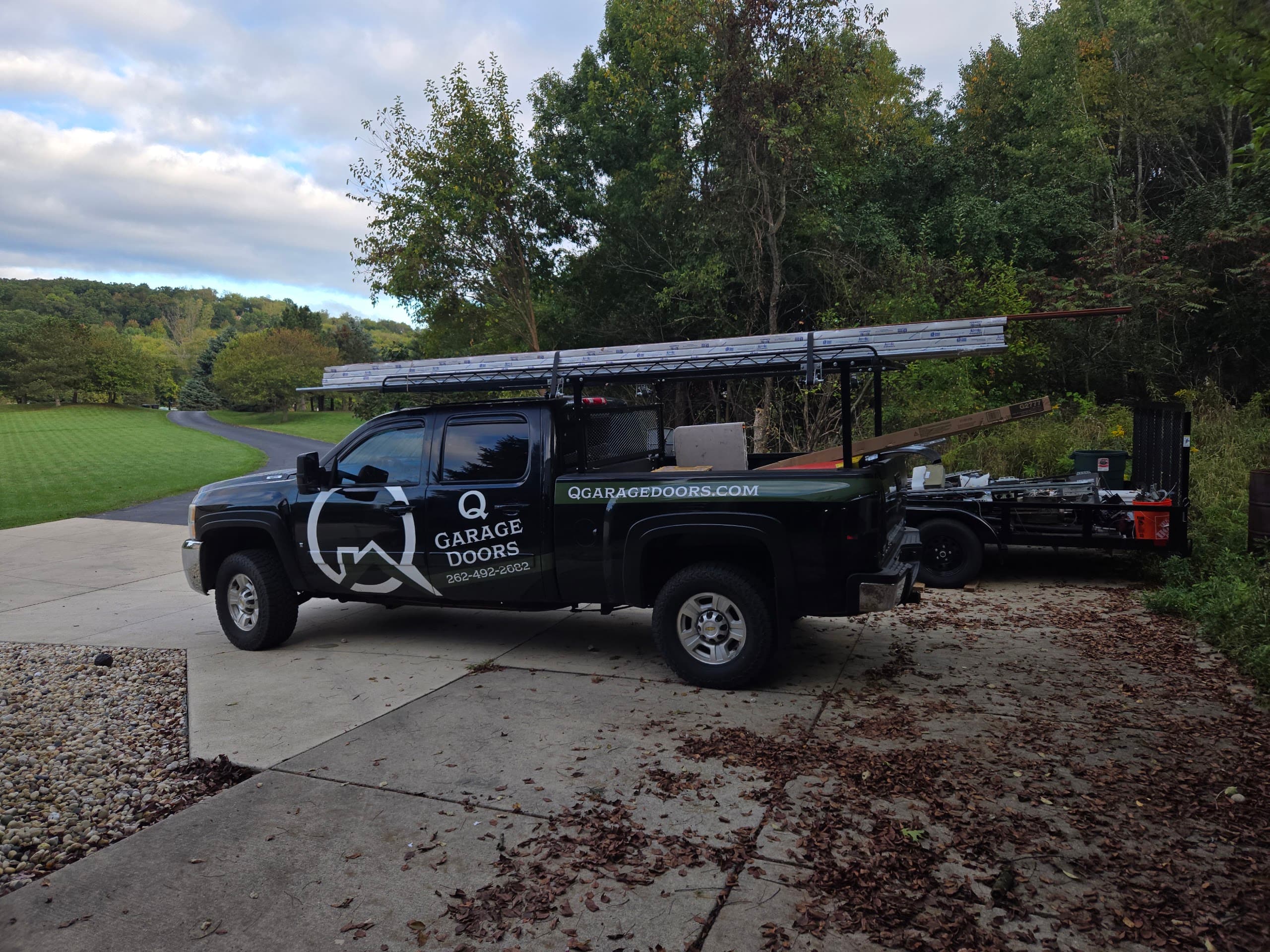 The Q Garage Doors truck loaded with door panels, headed to a job